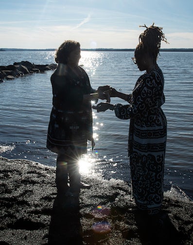 two women standing on the bank of the Potomac River