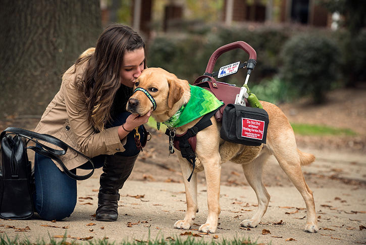 Mason student kisses service dog