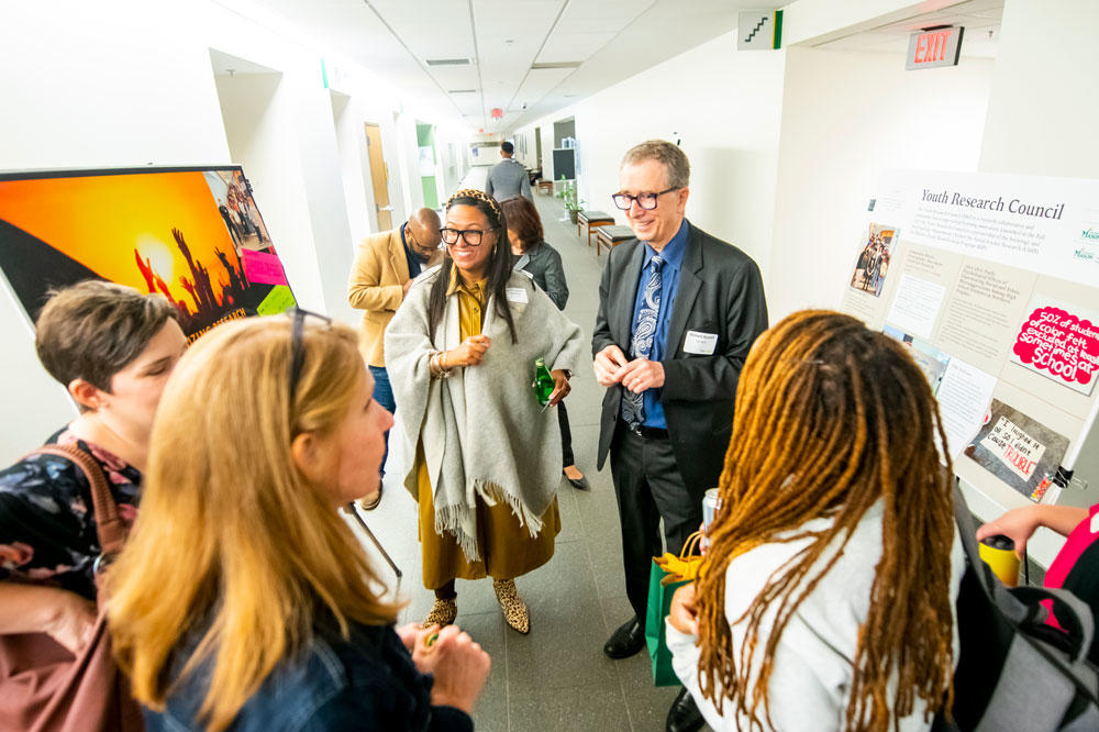 People reviewing a poster at the ARIE National Conference